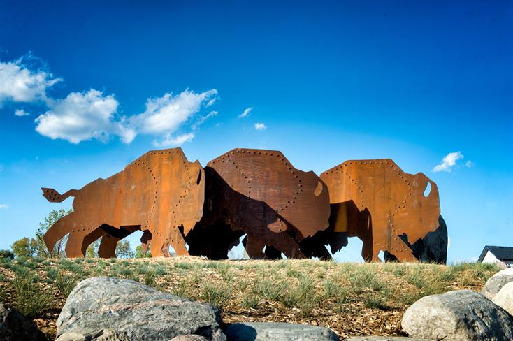 RidgeWood West Sculpture Running Bison and the Rubbing Stone - by David MacNair